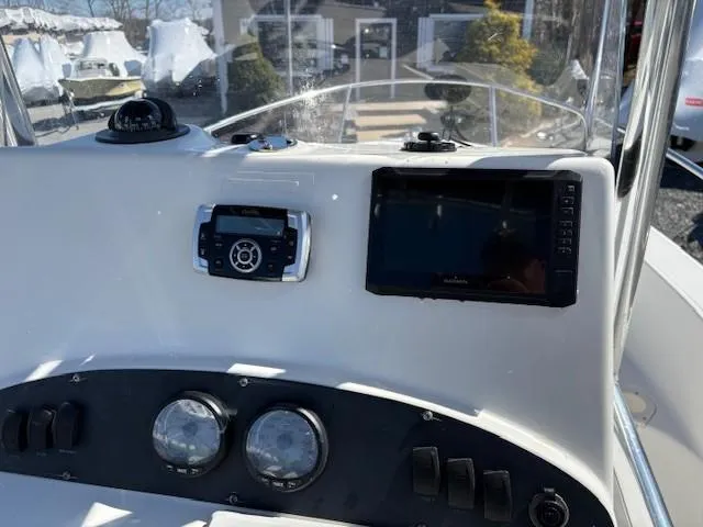 Slide: The Image of 2005 Boston Whaler 190 Nantucket dashboard with navigation instruments and controls. - 7