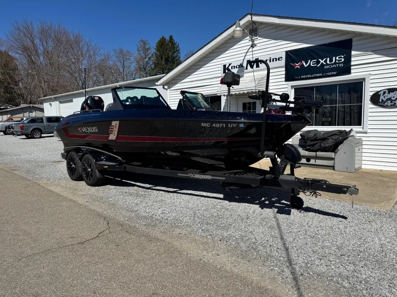 Slide: The Image of 2022 Vexus DVX20S boat on trailer outside dealership, sunny day. - 2
