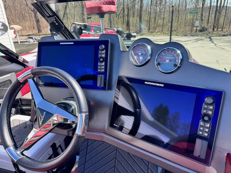 Slide: The Image of 2022 Vexus DVX20S boat dashboard with dual Humminbird displays and steering wheel. - 5