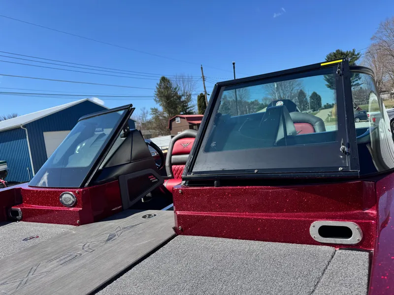 Slide: The Image of 2022 Vexus DVX20S boat with red seats and dual windshields under clear blue sky. - 9