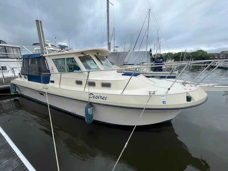 Slide: The Image of 2004 Albin 30 Family Cruiser docked at marina, overcast sky. - 0