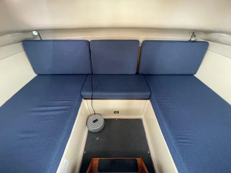 Slide: The Image of 2004 Albin 30 Family Cruiser interior with blue cushioned seating. - 23
