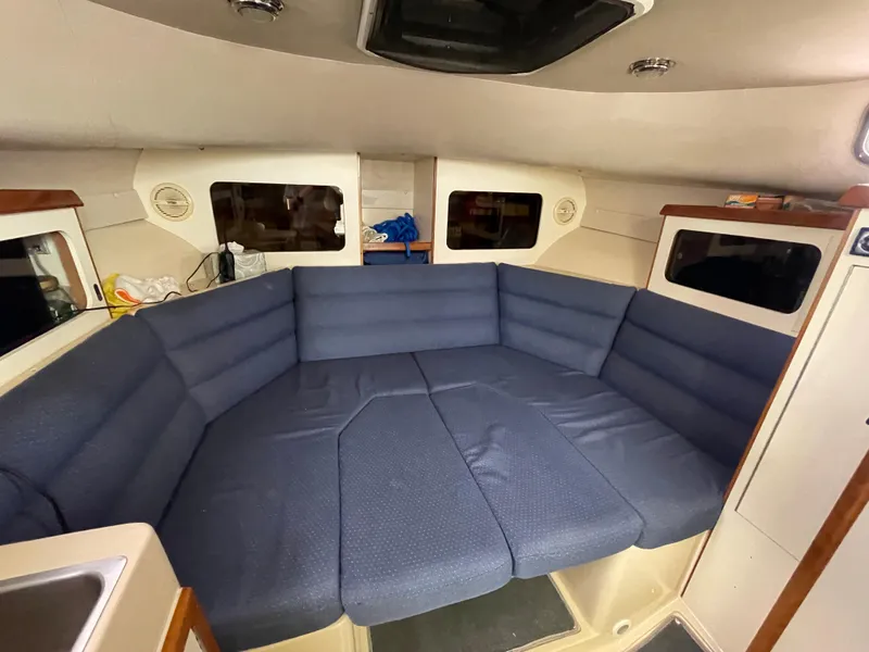Slide: The Image of 2004 Albin 30 Family Cruiser interior with blue cushioned seating area. - 30