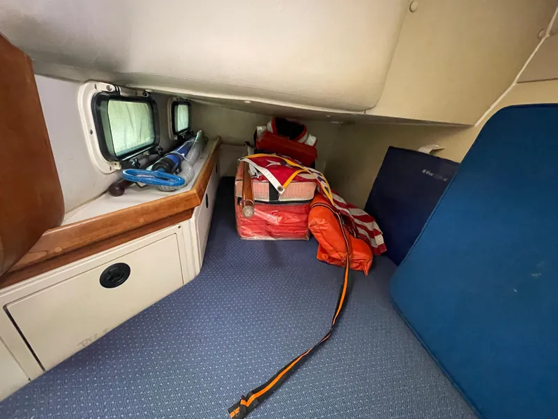 Slide: The Image of Interior cabin of a 2004 Albin 30 Family Cruiser with storage and life jackets. - 33