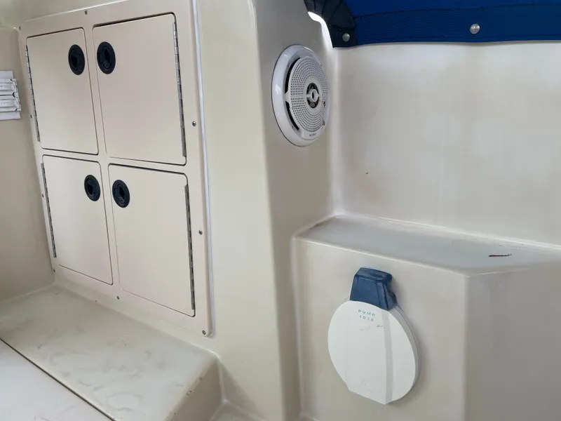 Slide: The Image of Interior view of a 2004 Albin 30 Family Cruiser boat, featuring storage compartments and a speaker. - 41