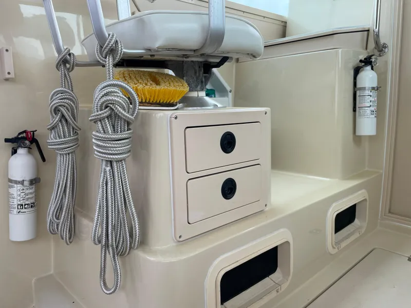 Slide: The Image of 2004 Albin 30 Family Cruiser interior with ropes, storage, and safety equipment. - 42