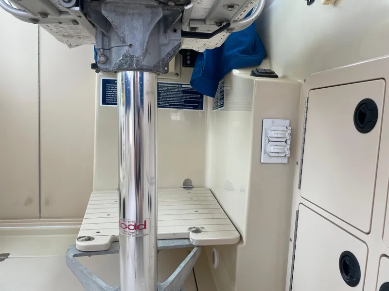 Slide: The Image of 2004 Albin 30 Family Cruiser interior with pedestal and storage compartments. - 43