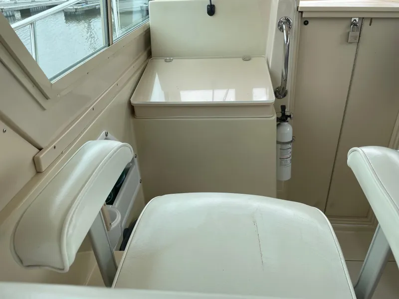 Slide: The Image of Interior of 2004 Albin 30 Family Cruiser with white seating and storage. - 44