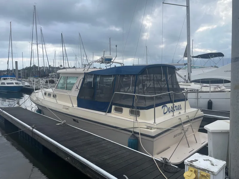 Slide: The Image of 2004 Albin 30 Family Cruiser docked at marina under cloudy skies. - 5