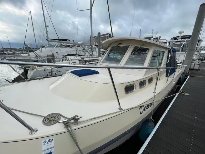 Slide: The Image of 2004 Albin 30 Family Cruiser docked at a marina under cloudy skies. - 8