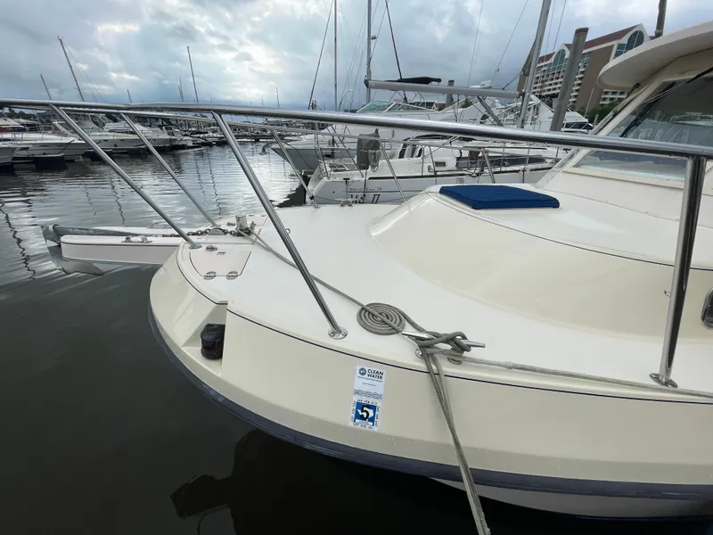 Slide: The Image of 2004 Albin 30 Family Cruiser docked at marina, featuring sleek design and mooring line. - 9