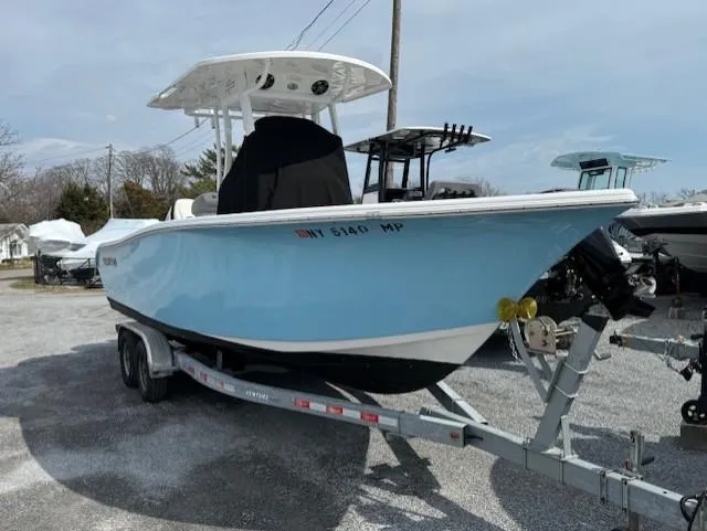 Slide: The Image of 2018 Sea Pro 239 Center Console boat on trailer, light blue hull. - 0