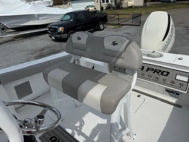 Slide: The Image of 2018 Sea Pro 239 Center Console boat with dual-tone seating and steering wheel. - 12