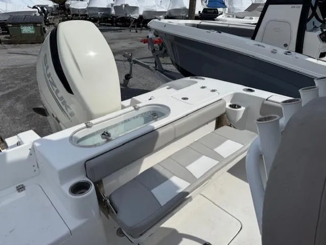 Slide: The Image of 2018 Sea Pro 239 Center Console boat with Suzuki outboard engine, featuring seating and storage. - 16
