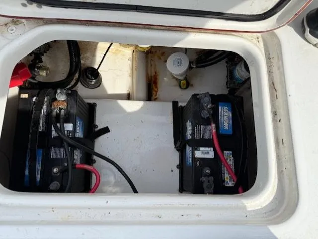 Slide: The Image of 2018 Sea Pro 239 Center Console boat battery compartment with dual batteries and wiring. - 17
