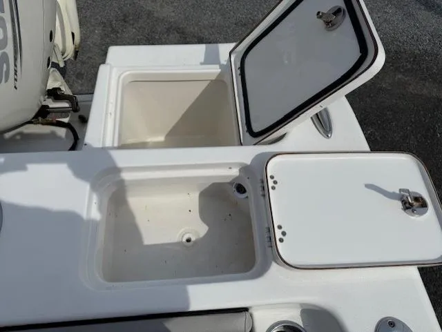 Slide: The Image of 2018 Sea Pro 239 Center Console boat storage compartments open. - 18