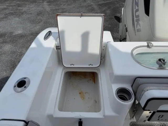 Slide: The Image of 2018 Sea Pro 239 Center Console boat with open storage compartment and Suzuki engine. - 19