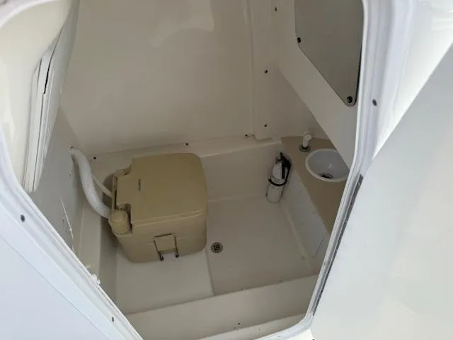 Slide: The Image of 2018 Sea Pro 239 Center Console boat interior with compact toilet and sink. - 20