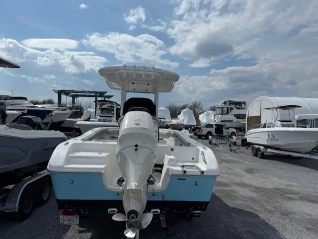 Slide: The Image of 2018 Sea Pro 239 Center Console boat in a marina, under a partly cloudy sky. - 3