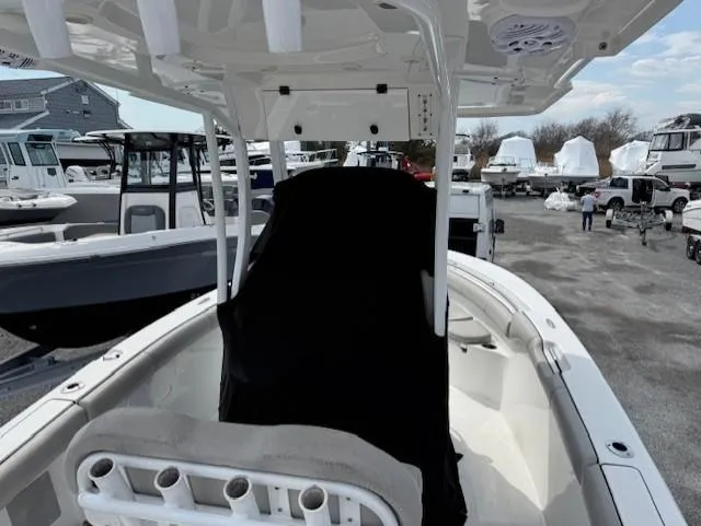 Slide: The Image of 2018 Sea Pro 239 Center Console boat with covered seating, docked among other vessels. - 7