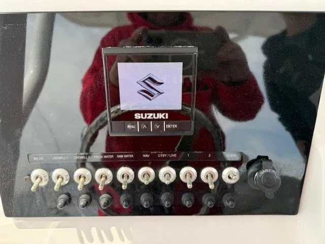 Slide: The Image of Control panel of a 2018 Sea Pro 239 Center Console boat with Suzuki display. - 9
