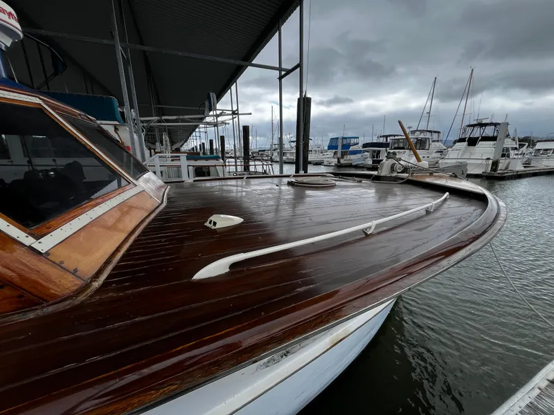 Slide: The Image of 1948 Chris-Craft Double Cabin boat docked at a marina under cloudy skies. - 10