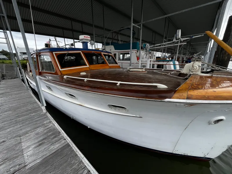 Slide: The Image of 1948 Chris-Craft Double Cabin boat docked under a covered marina. - 12
