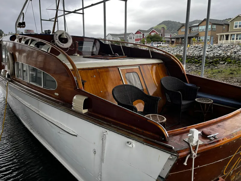 Slide: The Image of 1948 Chris-Craft Double Cabin boat with wooden deck, docked near waterfront homes. - 13