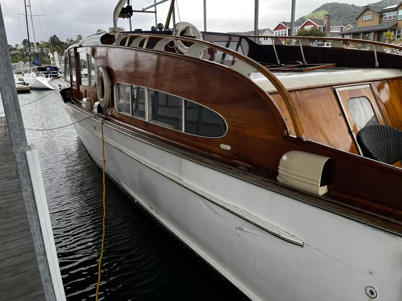 Slide: The Image of 1948 Chris-Craft Double Cabin boat docked, showcasing classic wooden design and elegant curves. - 14