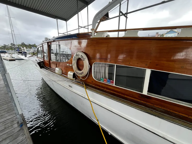 Slide: The Image of 1948 Chris-Craft Double Cabin boat docked, showcasing polished wood finish and classic design. - 15