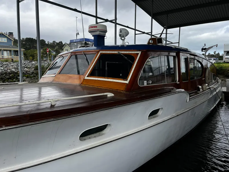 Slide: The Image of 1948 Chris-Craft Double Cabin boat docked under a covered marina. - 17