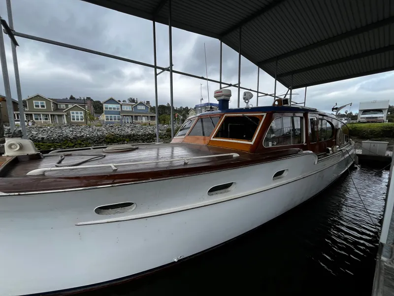 Slide: The Image of 1948 Chris-Craft Double Cabin boat docked under a covered marina. - 18