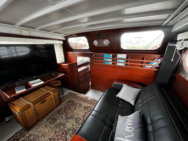 Slide: The Image of 1948 Chris-Craft Double Cabin interior with leather sofa, TV, and wooden accents. - 21