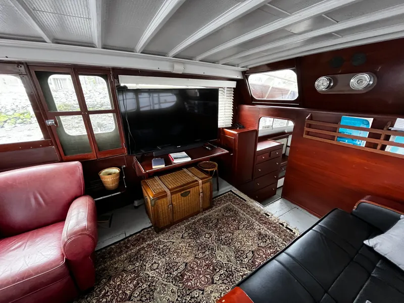 Slide: The Image of 1948 Chris-Craft Double Cabin interior with vintage decor, TV, and red leather seating. - 22