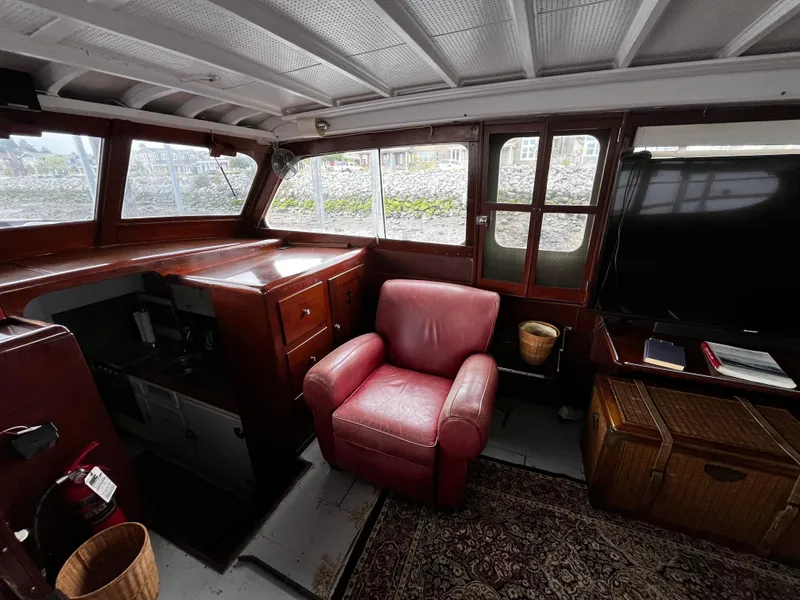 Slide: The Image of 1948 Chris-Craft Double Cabin interior with red armchair and wooden furnishings. - 23