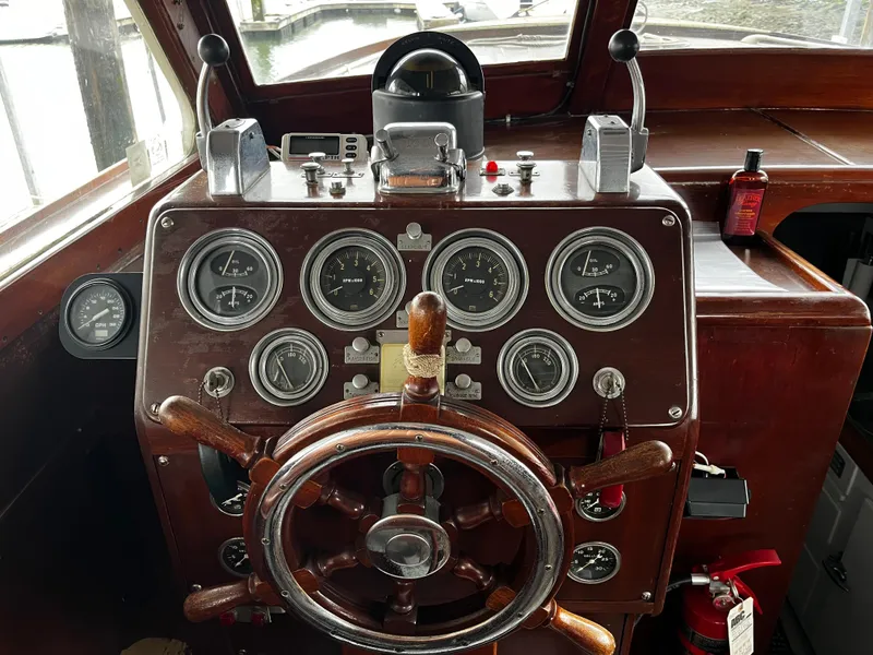 Slide: The Image of 1948 Chris-Craft Double Cabin dashboard with vintage wooden steering wheel and classic gauges. - 25