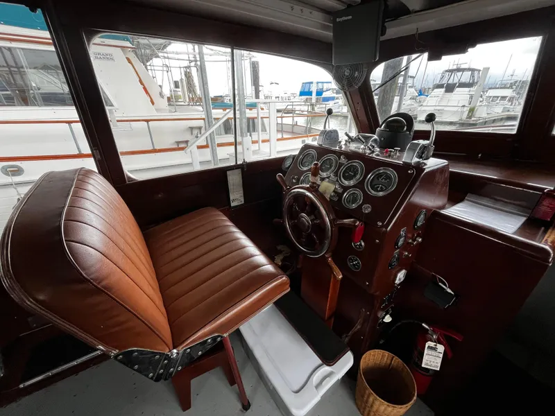 Slide: The Image of 1948 Chris-Craft Double Cabin helm with vintage controls and leather seat. - 26