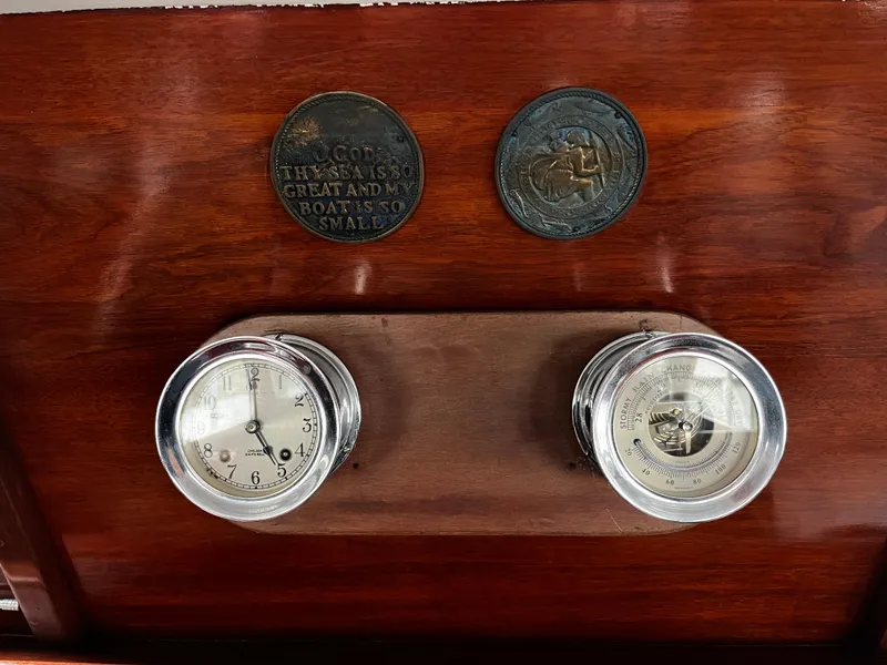 Slide: The Image of 1948 Chris-Craft Double Cabin dashboard with vintage clock and barometer on polished wood panel. - 27