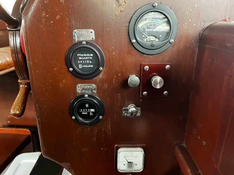Slide: The Image of 1948 Chris-Craft Double Cabin dashboard with gauges and controls on wooden panel. - 28