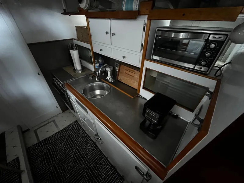 Slide: The Image of 1948 Chris-Craft Double Cabin kitchen with sink, microwave, and coffee maker. - 30