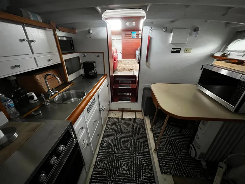 Slide: The Image of 1948 Chris-Craft Double Cabin interior with kitchen, dining area, and modern appliances. - 33