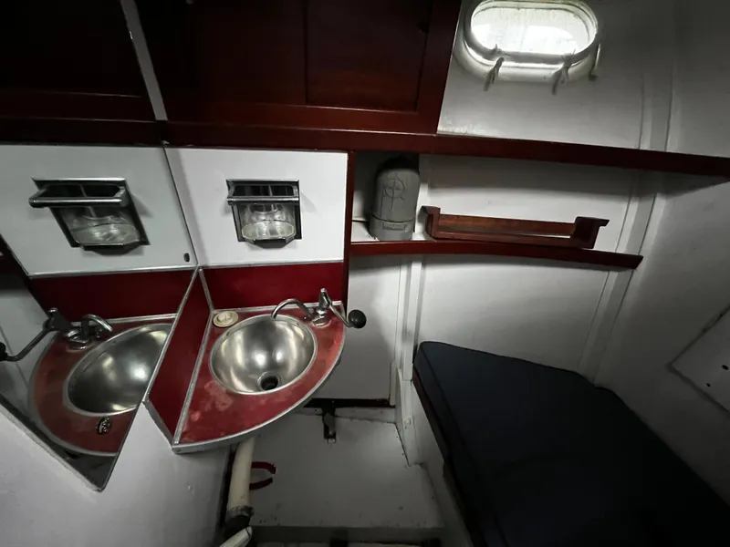 Slide: The Image of 1948 Chris-Craft Double Cabin interior with sink, mirror, and porthole window. - 36