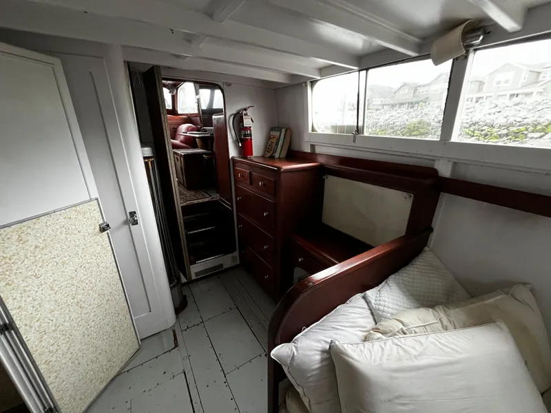 Slide: The Image of 1948 Chris-Craft Double Cabin interior with bed, drawers, and windows. - 38