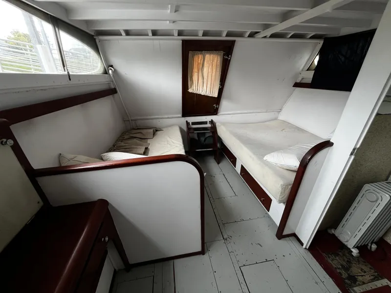Slide: The Image of 1948 Chris-Craft Double Cabin interior with twin beds and wooden accents. - 40