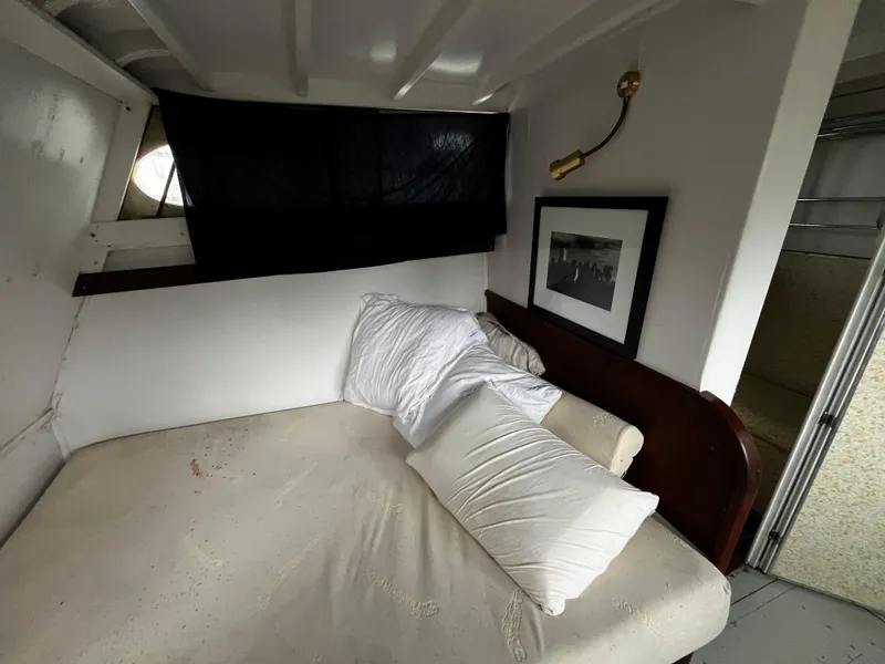 Slide: The Image of 1948 Chris-Craft Double Cabin interior with bed, pillows, and framed photo. - 42