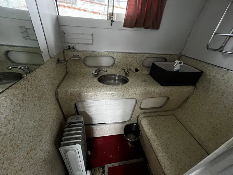 Slide: The Image of 1948 Chris-Craft Double Cabin bathroom with sink, heater, and storage. - 44