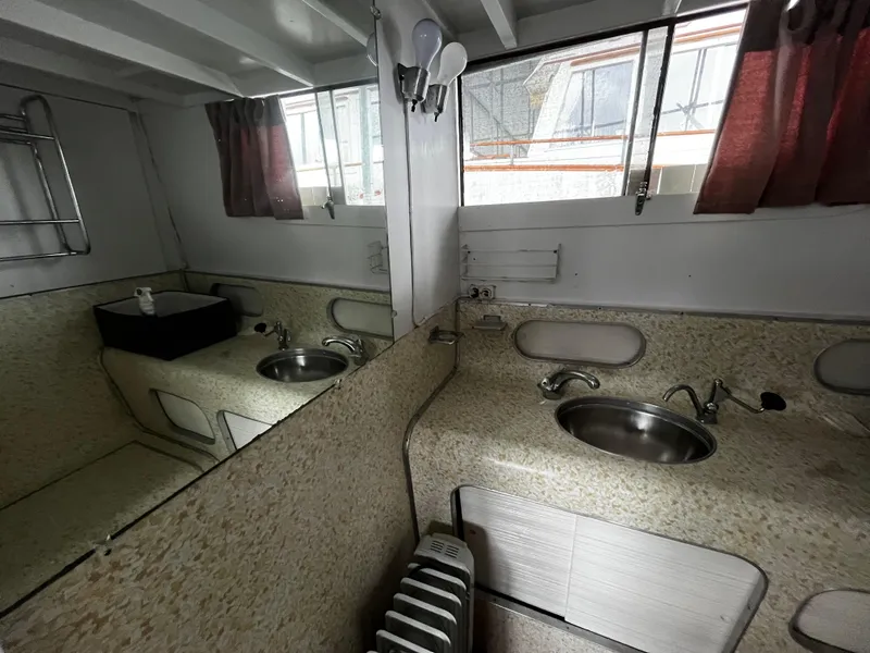 Slide: The Image of 1948 Chris-Craft Double Cabin bathroom with vintage sink, mirror, and window curtains. - 45