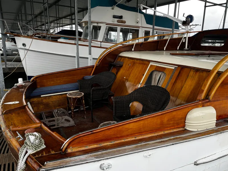 Slide: The Image of 1948 Chris-Craft Double Cabin boat with wooden deck and seating, docked in a marina. - 5