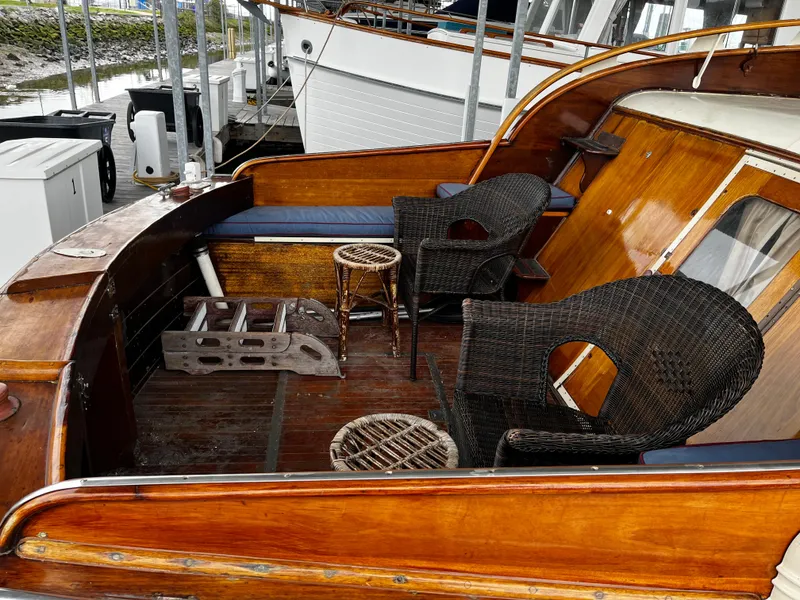 Slide: The Image of 1948 Chris-Craft Double Cabin boat with wicker chairs and wooden deck. - 6