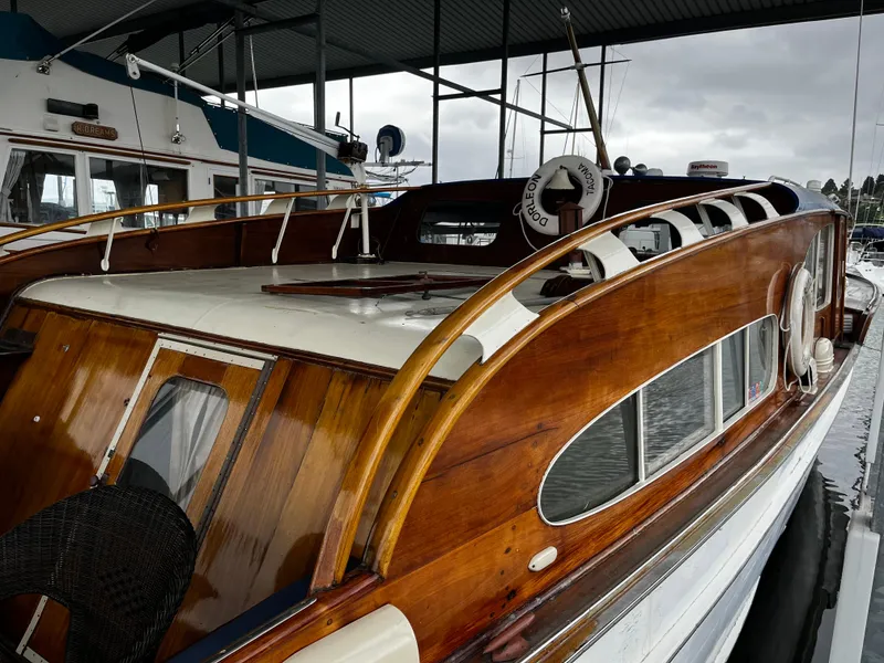 Slide: The Image of 1948 Chris-Craft Double Cabin boat with wooden finish docked under a covered marina. - 7